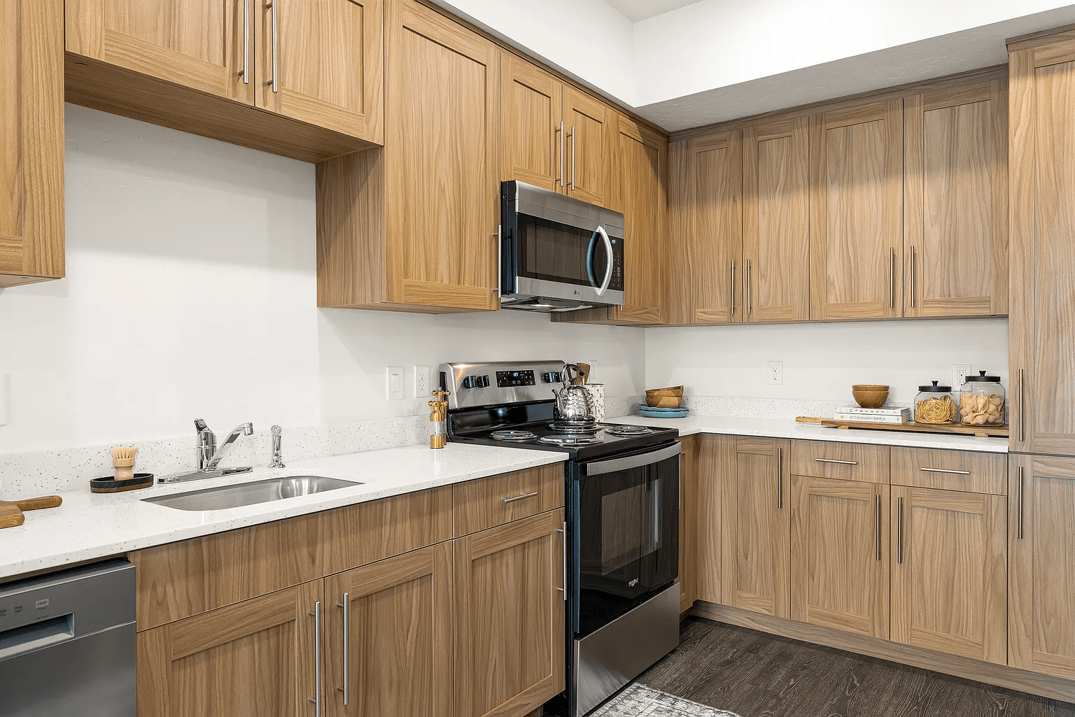 A kitchen with wooden cabinets and a black oven.